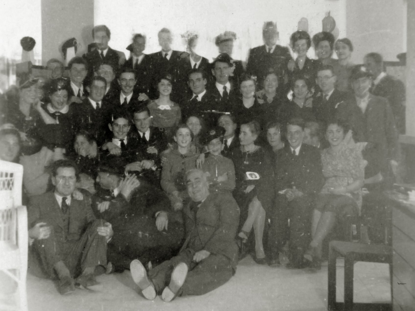 British servicemen and women hosted by Maltese Jewish families, 1940–41. Sitting on the floor: Fortunato Habib, George Tayar (talking), Marco Aroyo.