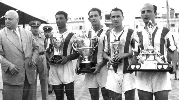 Photo: (left to right) Tony Cauchi, Pullu Demanuele, Lolly Borg and Lolly Debattista pose with the trophies won by Floriana in season 1954-55.